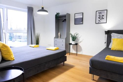 a bedroom with two beds and a sink in it at Four Bedroom in urban location in Hamburg