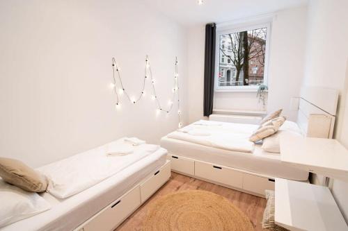 a room with two beds and a window at Great Three Bedroom Apartment in Hamburg