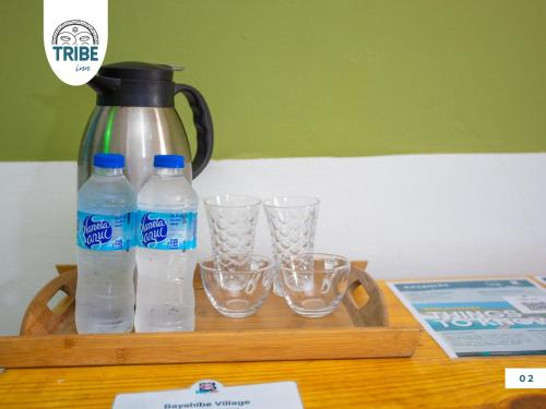 a tray with water bottles and glasses on a table at T Bayahibe in Bayahibe
