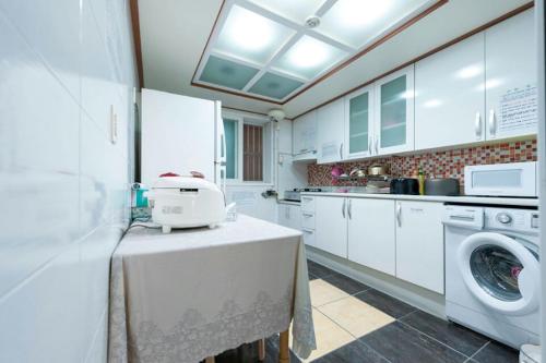 a kitchen with a washing machine on a table at NineRoD - Private bathroom & Shower in Seoul