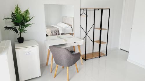 a white desk and a chair in a room at Villa Serafeim in Kymi