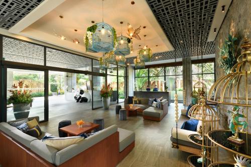 a living room with a couch and a table at Anantara Vacation Club Mai Khao Phuket in Mai Khao Beach