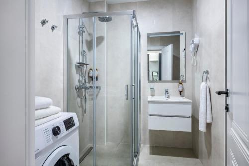 a bathroom with a shower and a sink at STEPS Batumi Hotel & Suites in Batumi