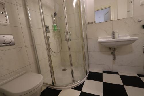a bathroom with a shower and a toilet and a sink at Fantastic - KP22 Room A in Warsaw