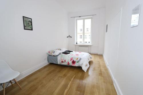 a white room with a bed and a window at Fantastic - KP22 Room A in Warsaw