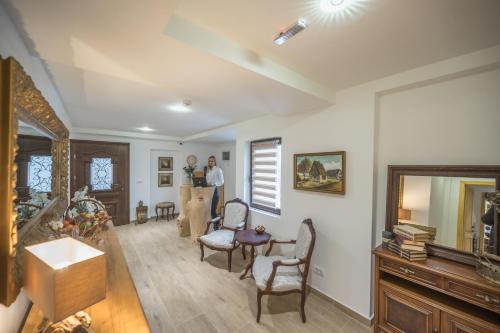 a man is standing in a living room at Konak Lecic in TrÅ¡iÄ‡