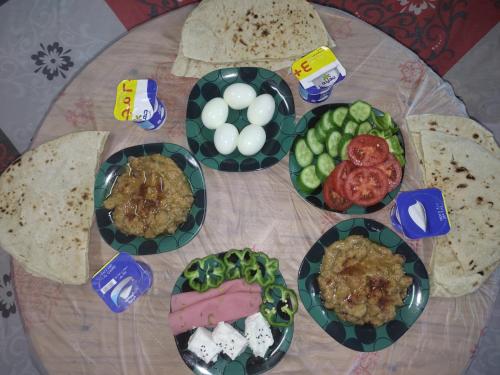 a table with plates of food on a table at Studio Merit Pyramids View in Cairo