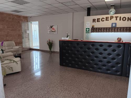 a waiting room with a reception counter in a hospital at Hotel vila veneto in Timişoara