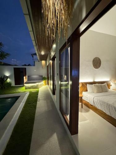 チャングーにあるVilla Floraのベッドとプールのある寝室