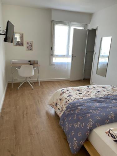 Schlafzimmer mit einem Bett, einem Schreibtisch und einem Stuhl in der Unterkunft Coliving - Chambre blanche in Sarcelles