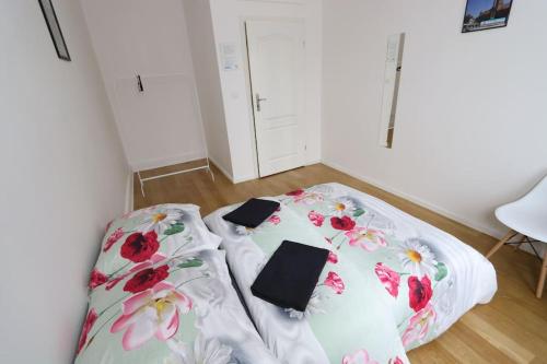 a bed in a room with flowers on it at Fantastic - KP22 Room D in Warsaw