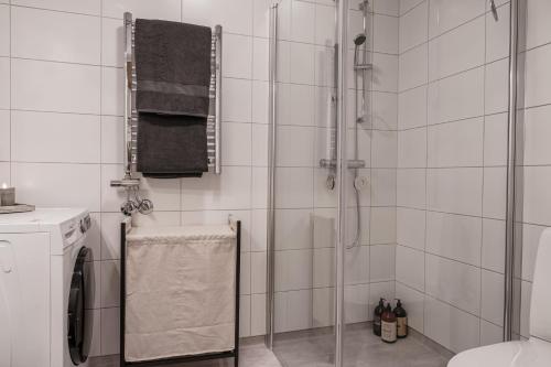 a bathroom with a shower with a glass door at Elite Studio - Work & Rest in Piteå
