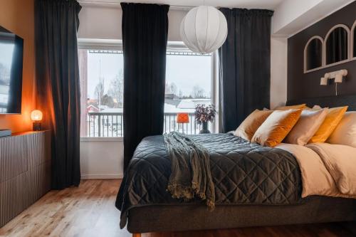 a bedroom with a large bed and a window at Elite Studio - Work & Rest in Piteå