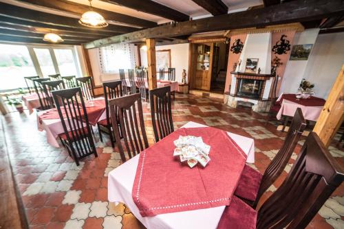 a dining room with a table and chairs and a fireplace at Gościniec Czapla in Dywity