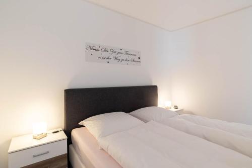 a bedroom with two beds and a sign on the wall at Ferienwohnung Theodor in Schilksee