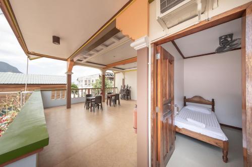 a room with a bed and a balcony at Zaniya's Pension in El Nido