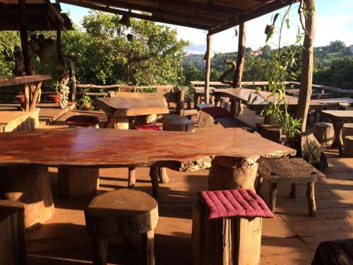 a wooden table and some benches and tables at Tree Top Eco-Lodge in Banlung