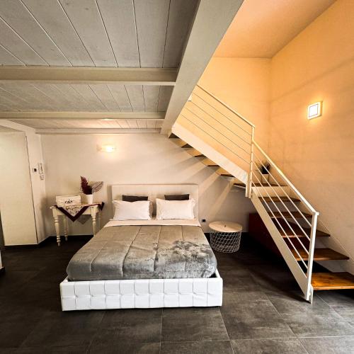 a bedroom with a bed and a staircase at Casa in Centro in Caserta