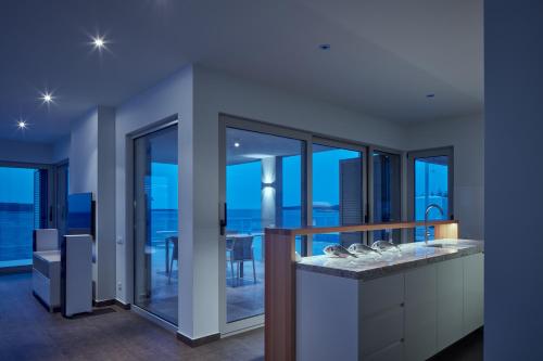 a bathroom with a view of the city at night at Villa Roca in Vis