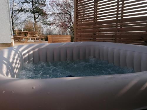 a hot tub with water in it in a backyard at Maison de campagne avec jacuzzi 