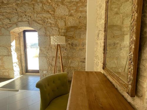 a dining room with a table and a mirror at Villa Dolce Valle in Ragusa