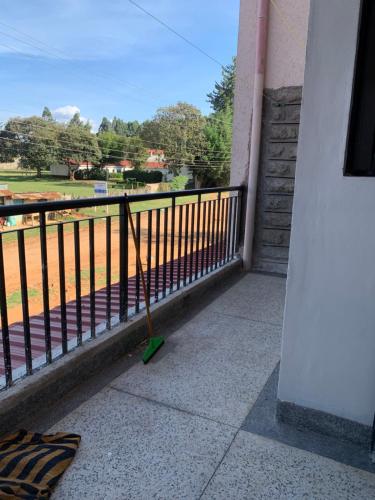 un cyclomoteur sur un balcon avec vue sur un champ dans l'établissement Rorot 1 bedroom Modern fully furnished space in Annex Eldoret with free wifi, à Eldoret