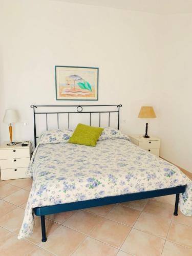 a bedroom with a bed and two night stands at Residenza l'Ulivo in Alberese