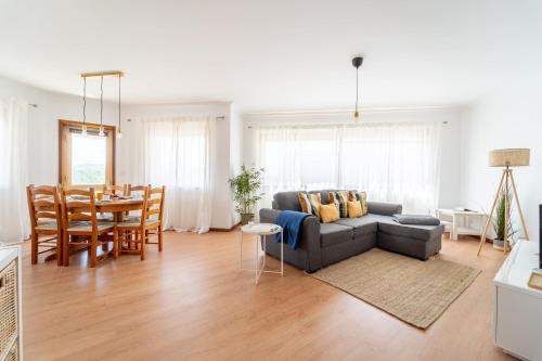 a living room with a couch and a table at Beach Flat by House and People in Viana do Castelo