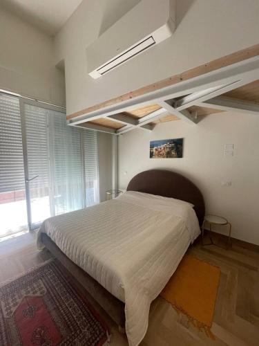 a bedroom with a large bed in a room at CASA LELA rimini SAN GIIULIANO in Rimini