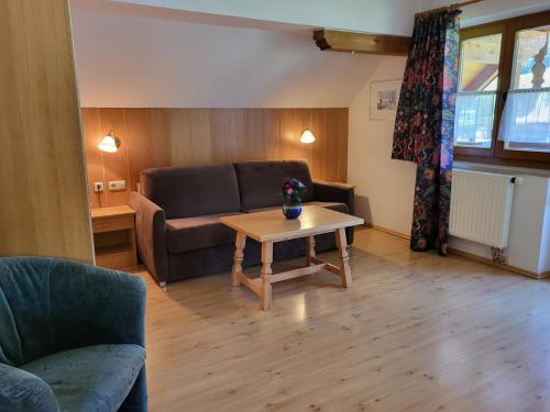a living room with a couch and a table at Appartements Höller in Sankt Lorenzen ob Murau