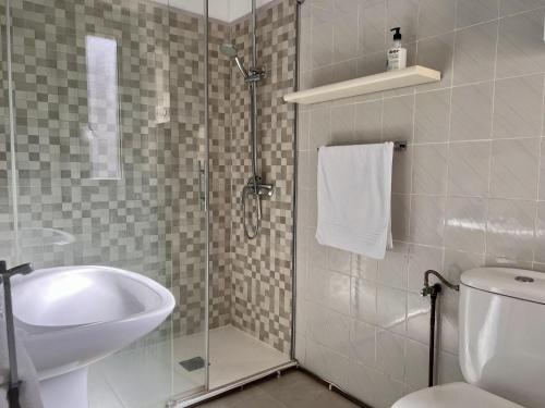 a bathroom with a shower and a sink and a toilet at Apartamento Somo Puerto in Somo