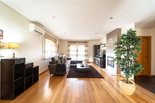 a living room with a couch and a table at Casa de Palmeira by House and People in Burgueiros