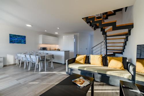 a living room with a couch and a staircase at Villa Tisa in Privlaka