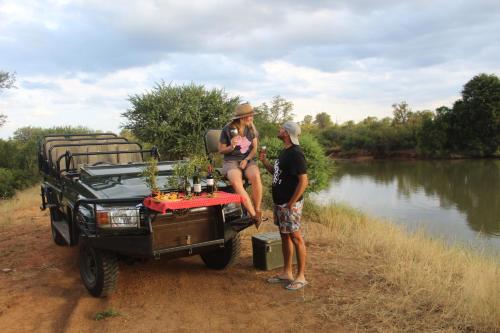 a man and a woman sitting on the back of a truck at Karongwe - Becks Safari Lodge in Hoedspruit