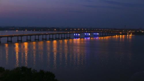 a bridge over a large body of water at night at Dnepropetrovsk Hotel in Dnipro