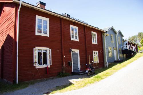 a red house with a motorcycle parked in front of it at STF Hostel Vilhelmina Kyrkstad in Vilhelmina