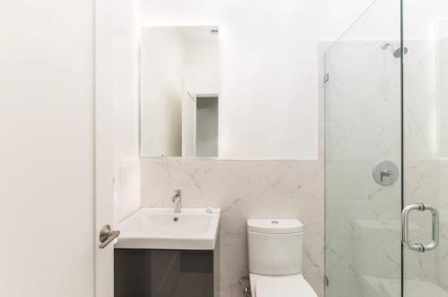 a bathroom with a toilet and a sink and a shower at Stylish Studio in Historic Boston - #206 in Boston