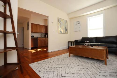a living room with a couch and a coffee table at Stylish Apartment in Malden 20 Min from Boston #2 in Malden