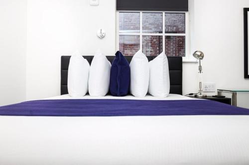 a group of pillows on top of a bed at Modern Studio in Historic Boston - Unit #102 in Boston