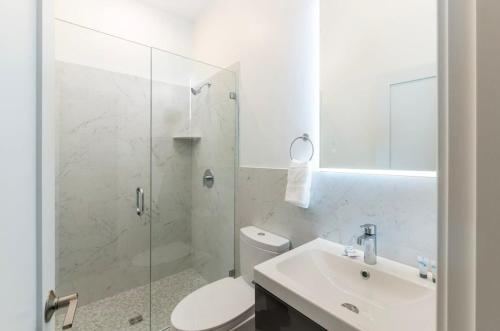 a bathroom with a toilet and a sink and a shower at Stylish Studio in Historic Boston - Unit #204 in Boston