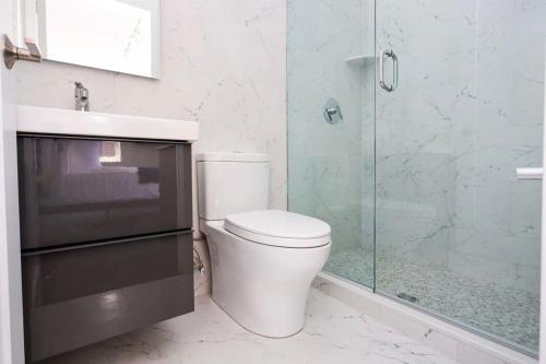 a bathroom with a toilet and a glass shower at Modern Studio in Historic Boston - Unit #302 in Boston