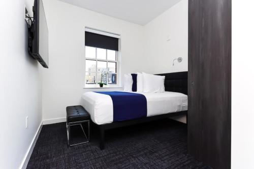 a hotel room with a bed and a window at Modern Studio in Historic Boston - Unit #403 in Boston