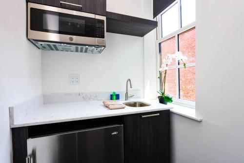 a kitchen with a sink and a microwave at Stylish Studio in Historic Boston - Unit #405 in Boston