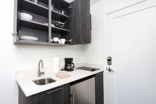 a kitchen with a sink and a counter top at Stylish Studio in Fenway Neighborhood - Unit #306 in Boston