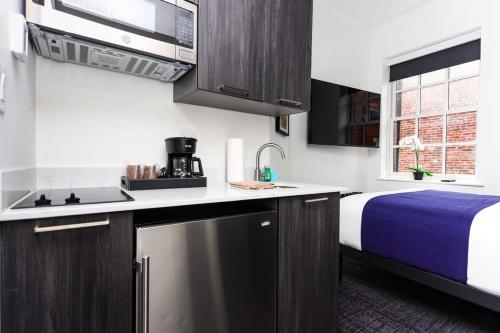 a kitchen with a sink and a bed in a room at Stylish Studio in Historic Boston - Unit #404 in Boston