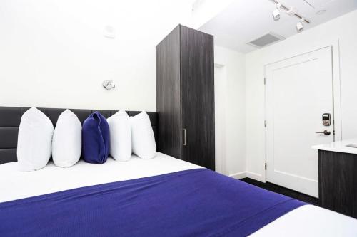 a bedroom with a bed with blue and white pillows at Stylish Studio in Historic Boston - Unit #404 in Boston