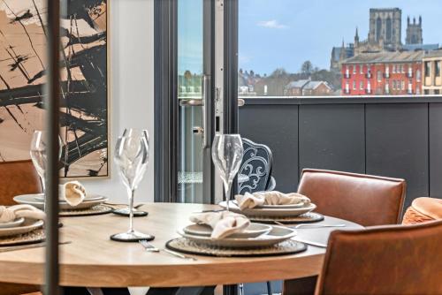 a table with plates and glasses on a balcony with a view at Apartment 47 with secure Free parking in York