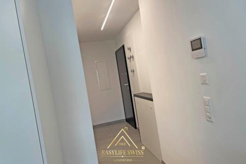 a hallway leading to a room with a sign on the wall at Rame Loft per 4 Persone a Bellinzona -By EasyLife Swiss in Bellinzona