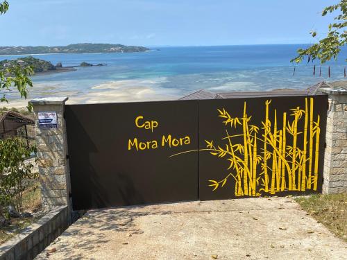 a gate with the words cap moro moca on it at Villa luxueuse avec une vue extraordinaire in Andilana