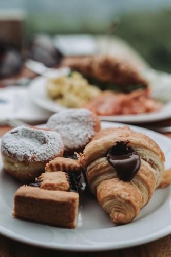 a plate of different types of pastries on a table at Hotel Gabbiano - Garda Lake Collection in Garda